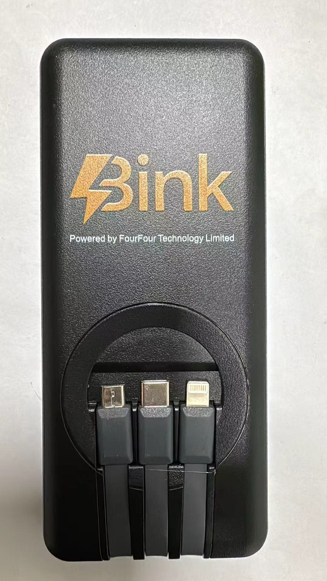 Front of a black Bink portable charger with three attached connectors
